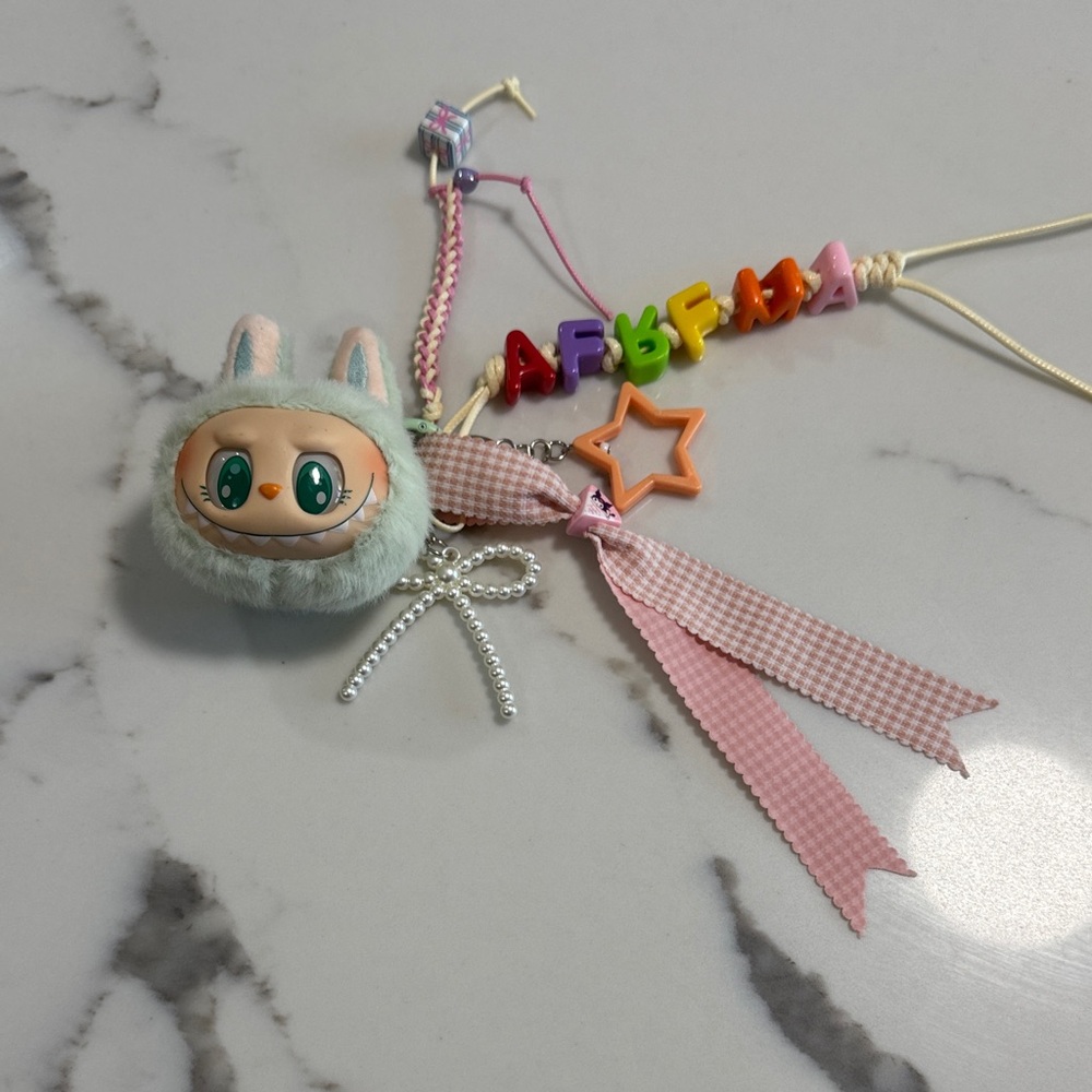 Green and Pink Labubu bag charm.